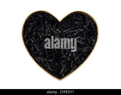 Top view of empty open heart shaped gift box with black color shredded paper - gift box filler. Luxury present wrapping or products background. Stock Photo