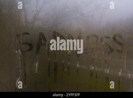 Sadness inscription on glass concept Stock Photo
