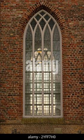 Gothic windows in brick wall of historic church of Hollum on the Dutch Wadden Island of Ameland Stock Photo