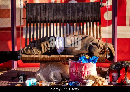 Philadelphia, homeless man sleeps on benches near the railway station Stock Photo