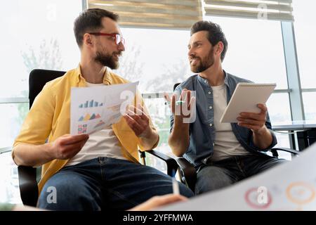 Two entrepreneurs are discussing about data and planning new strategies for their business Stock Photo