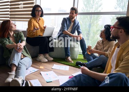 Team of young creative professionals is having a productive meeting, brainstorming and discussing new ideas for their next project Stock Photo