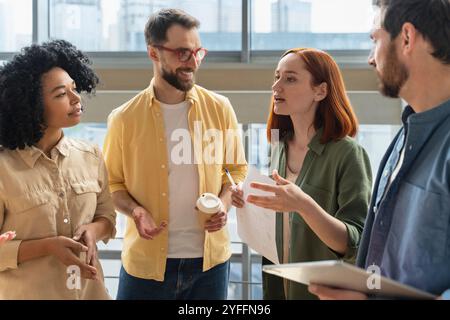 Group of diverse businesspeople is having an informal meeting discussing business issues in a modern office Stock Photo