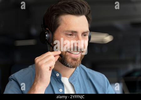 Customer service representative wearing headset talking with customer and smiling Stock Photo