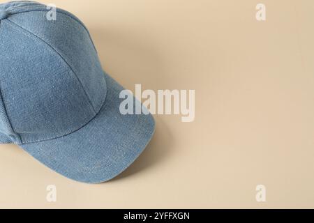 Stylish denim baseball cap on beige background. Mockup for design Stock Photo