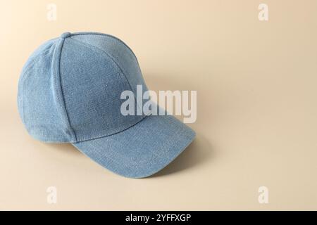 Stylish denim baseball cap on beige background. Mockup for design Stock Photo