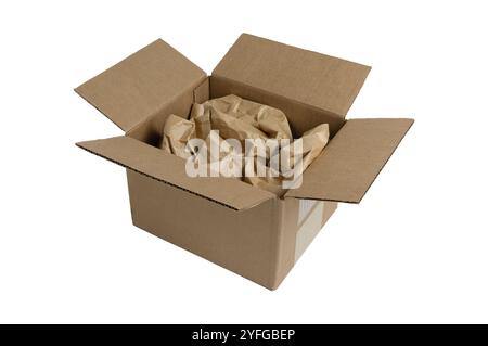 An open cardboard box filled with crumpled brown packing paper, isolated on a light grey background. The image highlights simple, sustainable packagin Stock Photo