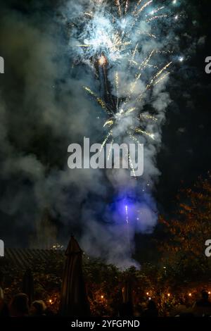 Families gather to watch a fireworks display in a pub beer garden to celebrate the tradition of Guy Fawkes night, also known as bonfire night Stock Photo