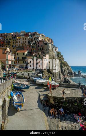 View of colorfulm houses around the tiny harbor of Manarola, Cinque Terre, province of La Spezia, part of the region of Liguria, Northern Italy. Stock Photo