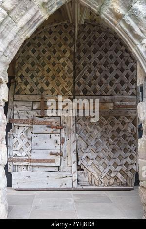 Chepstow castle, twelfth century wooden door of the gatehouse,  Monmouthshire, Wales Stock Photo