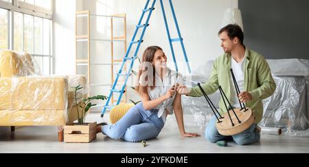 Young couple assembling furniture at home Stock Photo