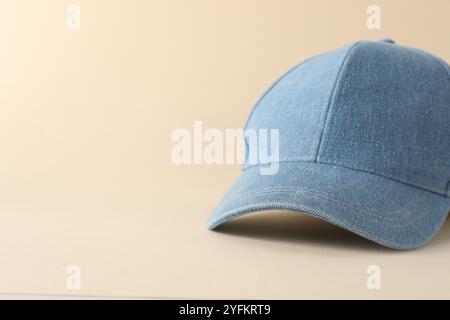 Stylish denim baseball cap on beige background, closeup. Mockup for design Stock Photo