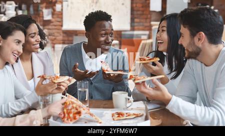 International group of coworkers enjoying pizza together Stock Photo