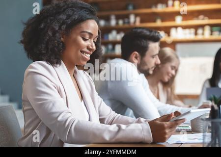 Afro woman using digital tablet during business meeting Stock Photo