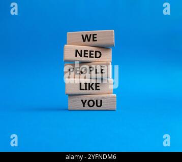 Hiring symbol. Wooden blocks with words We need People like You. Beautiful blue background. Business and Hiring concept. Copy space. Stock Photo