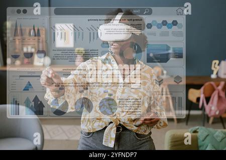 Using Virtual Reality Headset in Modern Living Room Stock Photo