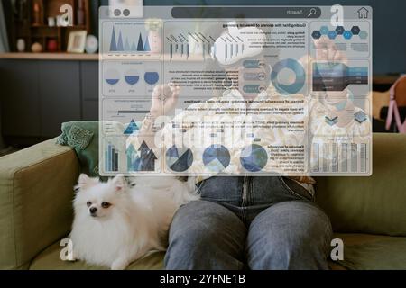Using Virtual Reality While Sitting on Couch with Dog Stock Photo