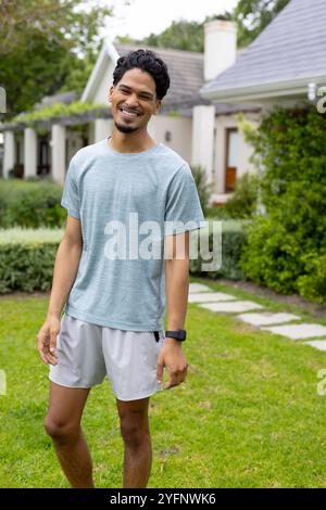 Smiling young man enjoying sunny day outdoors in casual outfit Stock Photo