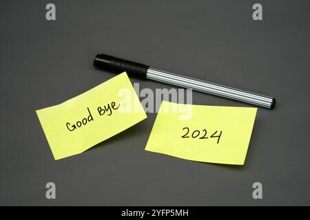 goodbye 2024 handwritten text on yellow stick note Stock Photo