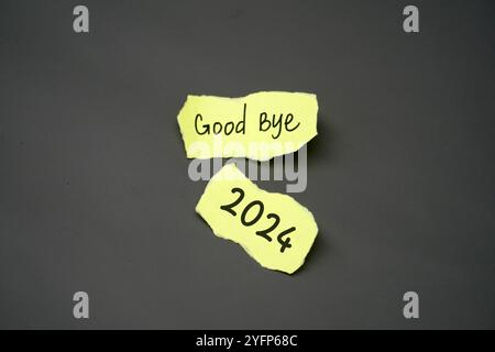 handwritten text "Good bye 2024" on a yellow torn paper Stock Photo