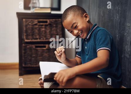 Boy, thinking and books for studying in home, ponder answer and school preparation for test. Male person, education and student for learning on floor Stock Photo