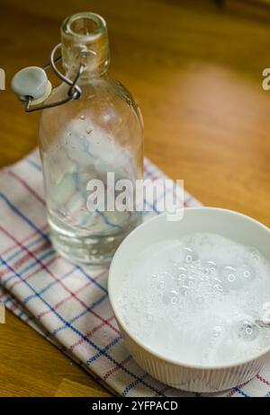 glass bottle with vinegar and bowl with solution of vinegar, soda and soap. High quality photo Stock Photo