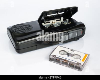 Audio micro cassette recorder and micro cassette tape in foreground, isolated on white background Stock Photo