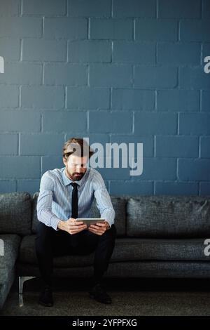 Online, tablet and reading with business man for cloud solutions architect, it consultant or mockup. Web, framework and search with person on wall Stock Photo