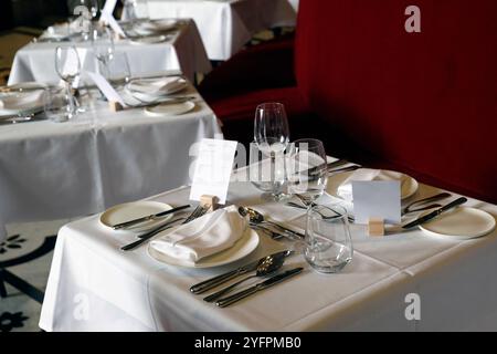 Elegant table setting in the restaurant. Several types of glass, plates and cutlery.  Vienna. Austria. Stock Photo