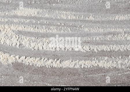 Grey cooking background of spilled wheat flour on stone background, top view. Stock Photo