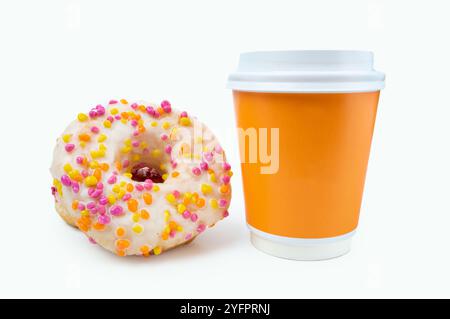 Blank yellow takeaway cup of coffee with a white lid. Glazed white donut icing with sprinkles nearby. Isolated on white background. Copy space, close- Stock Photo