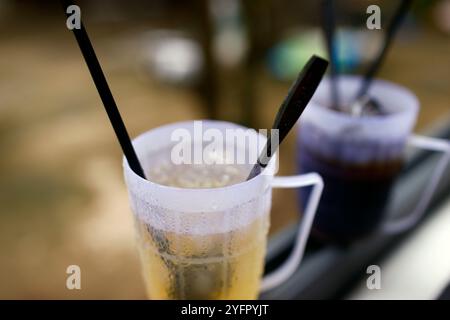 Ice tea in a plastic glass.  An Giang Province. Mekong Delta, Vietnam. Stock Photo