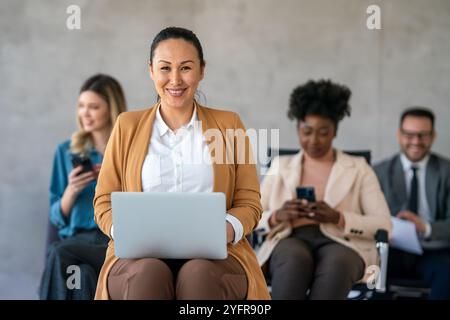 Mixed team of software engineers brainstorming ideas. Diverse app developers collaborating as group Stock Photo