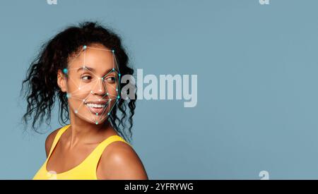 Smiling woman with curly hair and facial recognition technology on display Stock Photo