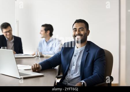 Positive confident young Indian leader of company posing for portrait Stock Photo