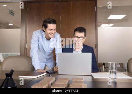 Two happy business partners using modern technology for teamwork Stock Photo