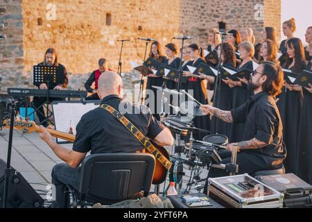21 September 2024, Ram, Serbia: Outdoor concert scene featuring a vibrant choir and band performing together, highlighting the energy of live music in Stock Photo