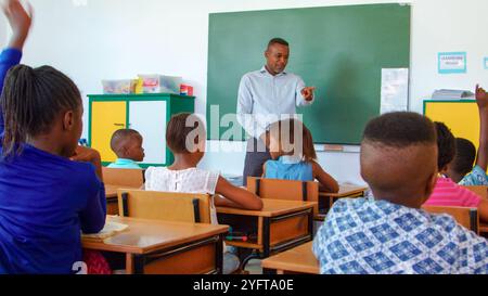 Teacher encourages student participation in a lively classroom discussion. Stock Photo