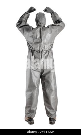 Protective equipment. Man wearing a dark gray protective suit, goggles, a mask, and gloves. The concept of safety gear. Stock Photo