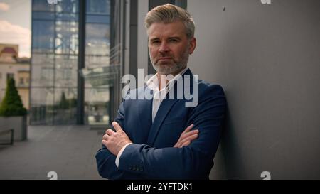 Caucasian middle-aged old man serious confident senior businessman mature retired business male employer 60s entrepreneur investor leader in city Stock Photo
