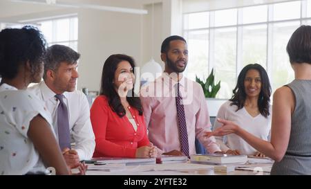 Multi-Cultural Business Team Meeting In Modern Open Plan Architects Office Together Stock Photo