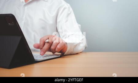 Business accounting concept. Business uses calculator with laptop computer, budget and income concept, sales concept, company accounting management. Stock Photo