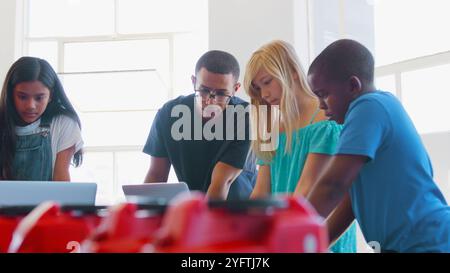 Students With Male Teacher In School Computer Coding Class Learn To Program Robot Vehicle Stock Photo