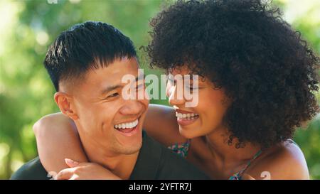 A joyful couple enjoys a lighthearted moment in nature. Stock Photo