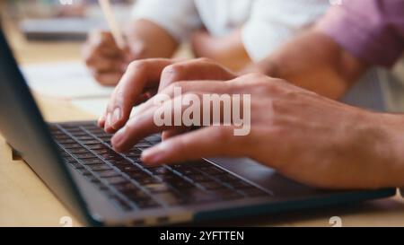 Close Up Of Businessman Typing On Laptop Computer Keyboard In Modern Office Stock Photo