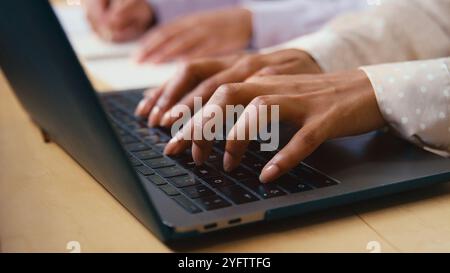 Close Up Of Businesswoman Typing On Laptop Computer Keyboard In Modern Office Stock Photo