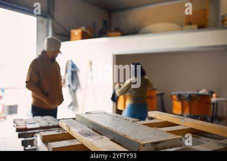 Male And Female Workers In Concrete Workshop Stock Photo