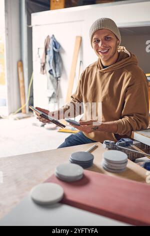 Portrait Of Male Worker In Concrete Workshop Using Digital Tablet And Stylus Checking Samples Stock Photo
