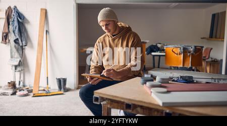Male Worker In Concrete Workshop Using Digital Tablet And Stylus Stock Photo