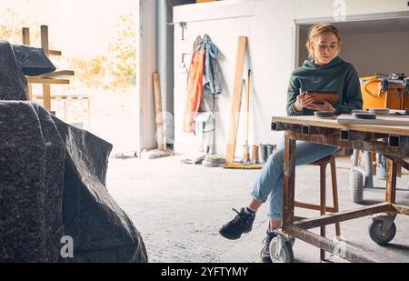 Female Worker In Concrete Workshop Using Digital Tablet And Stylus Stock Photo